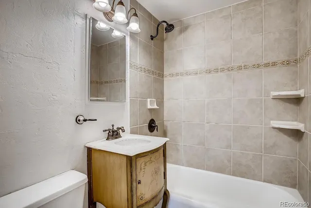 a bathroom with a sink mirror toilet and bathtub