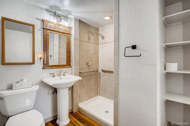 a bathroom with a sink toilet and shower