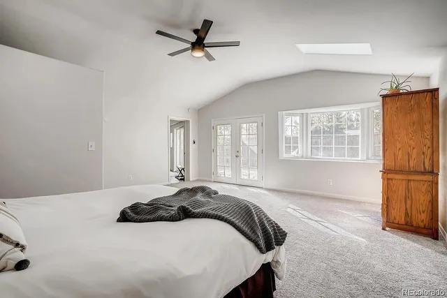 a bedroom with a large bed and a chandelier