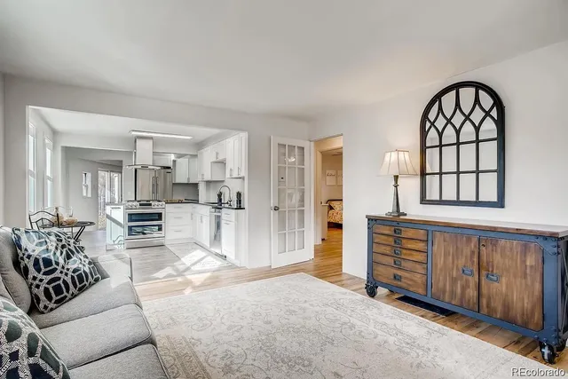 a living room with furniture and wooden floors