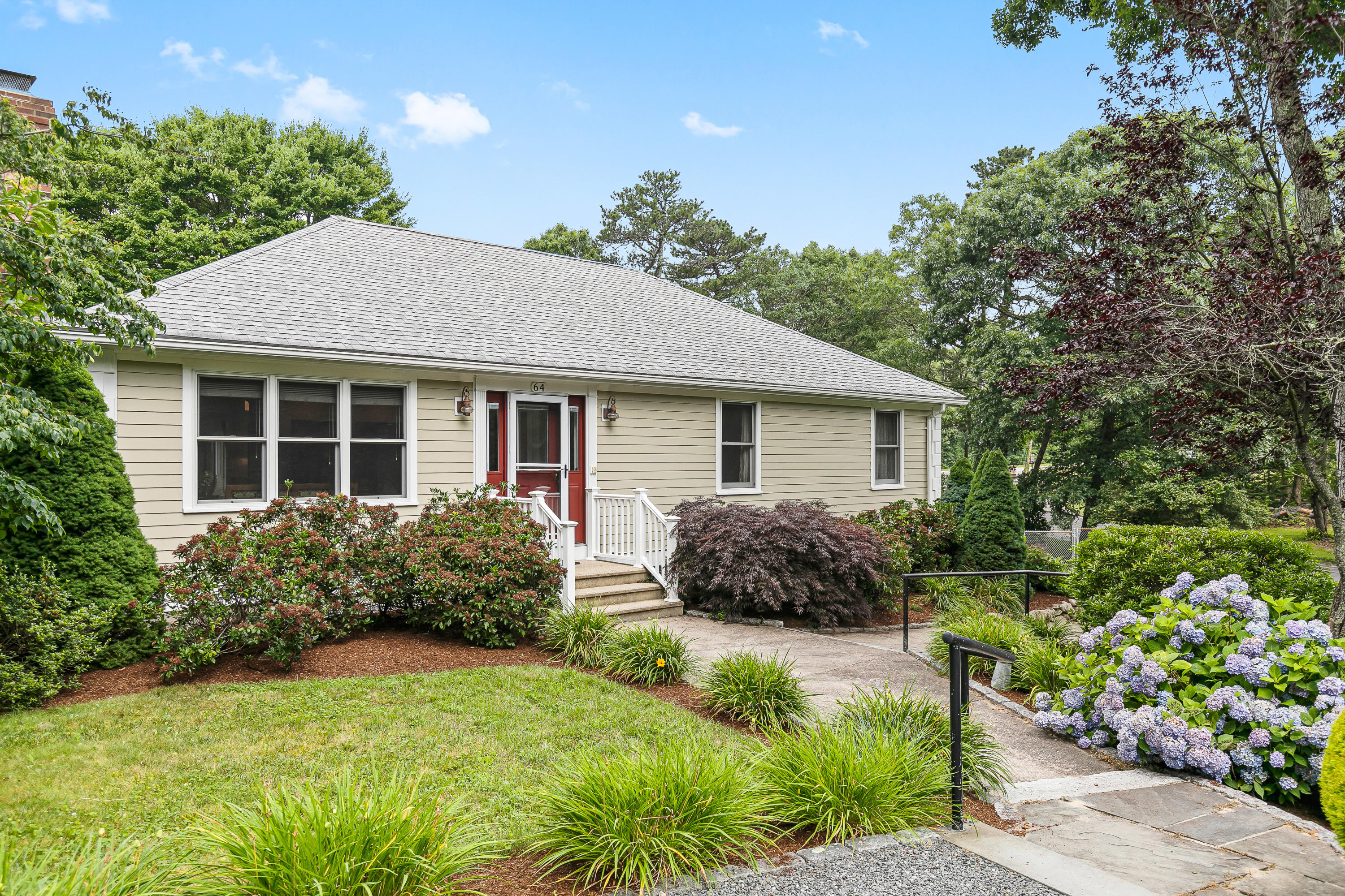 a front view of house with yard and green space