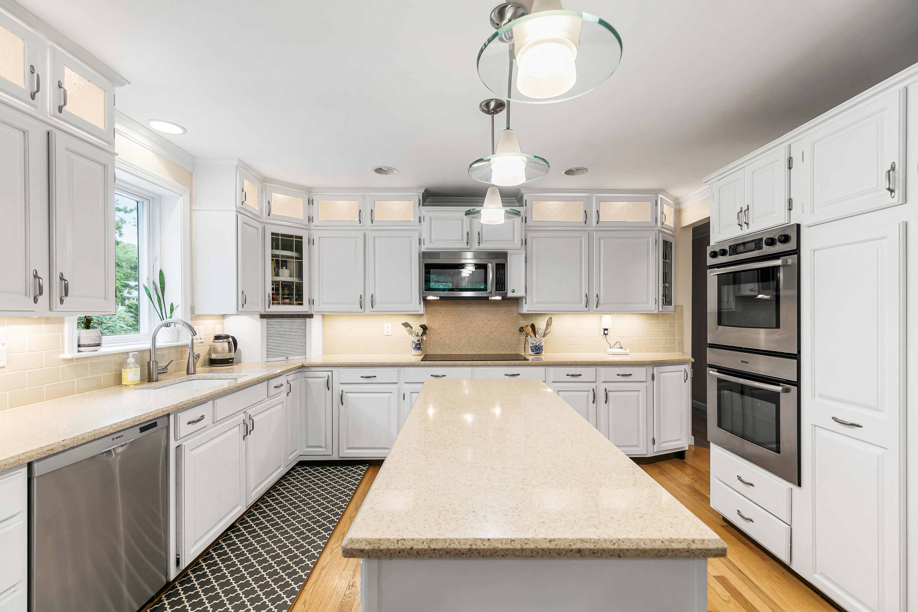 64 Hilltop Road Mashpee, MA 02649 - Photo 14 of 36 a large kitchen with cabinets a sink and dishwasher a stove with wooden floor