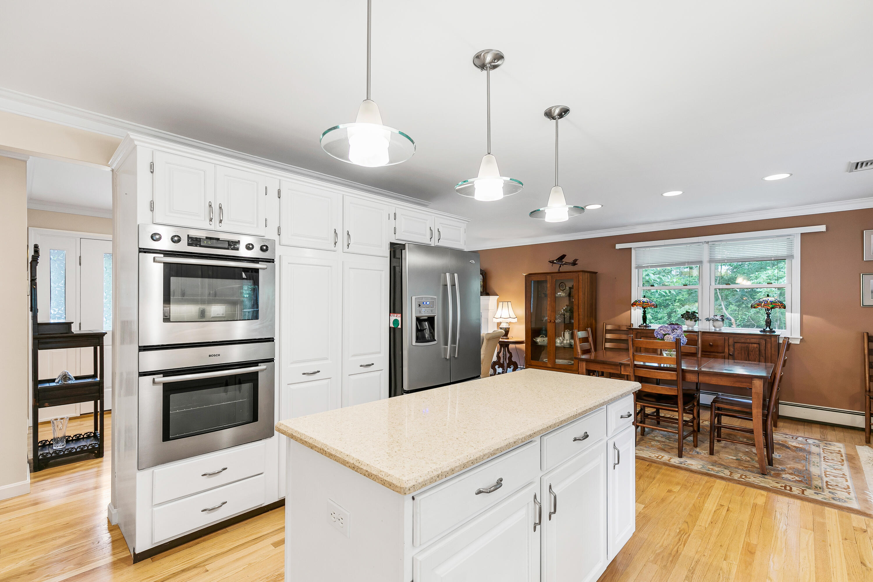 64 Hilltop Road Mashpee, MA 02649 - Photo 18 of 36 a kitchen with stainless steel appliances a stove a refrigerator a kitchen island a sink white cabinets and wooden floor
