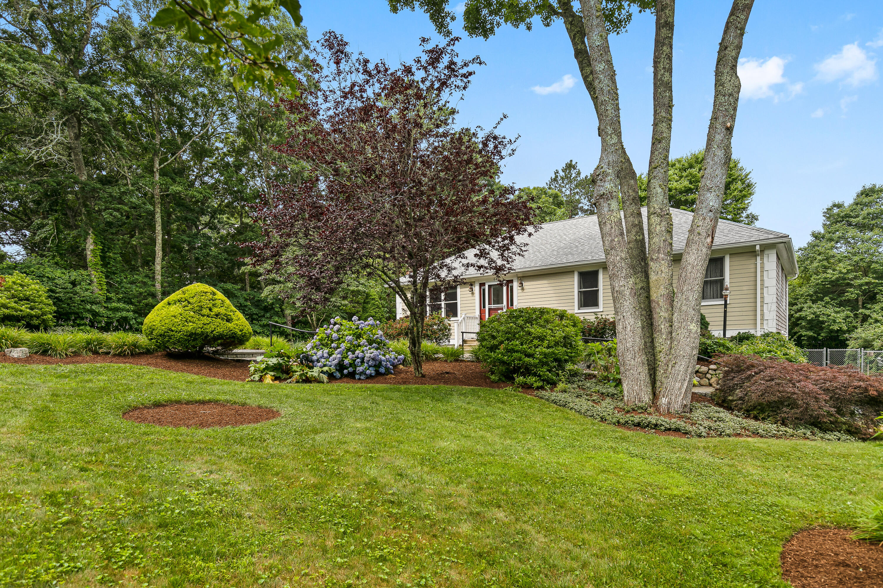 64 Hilltop Road Mashpee, MA 02649 - Photo 2 of 36 a front view of a house with garden
