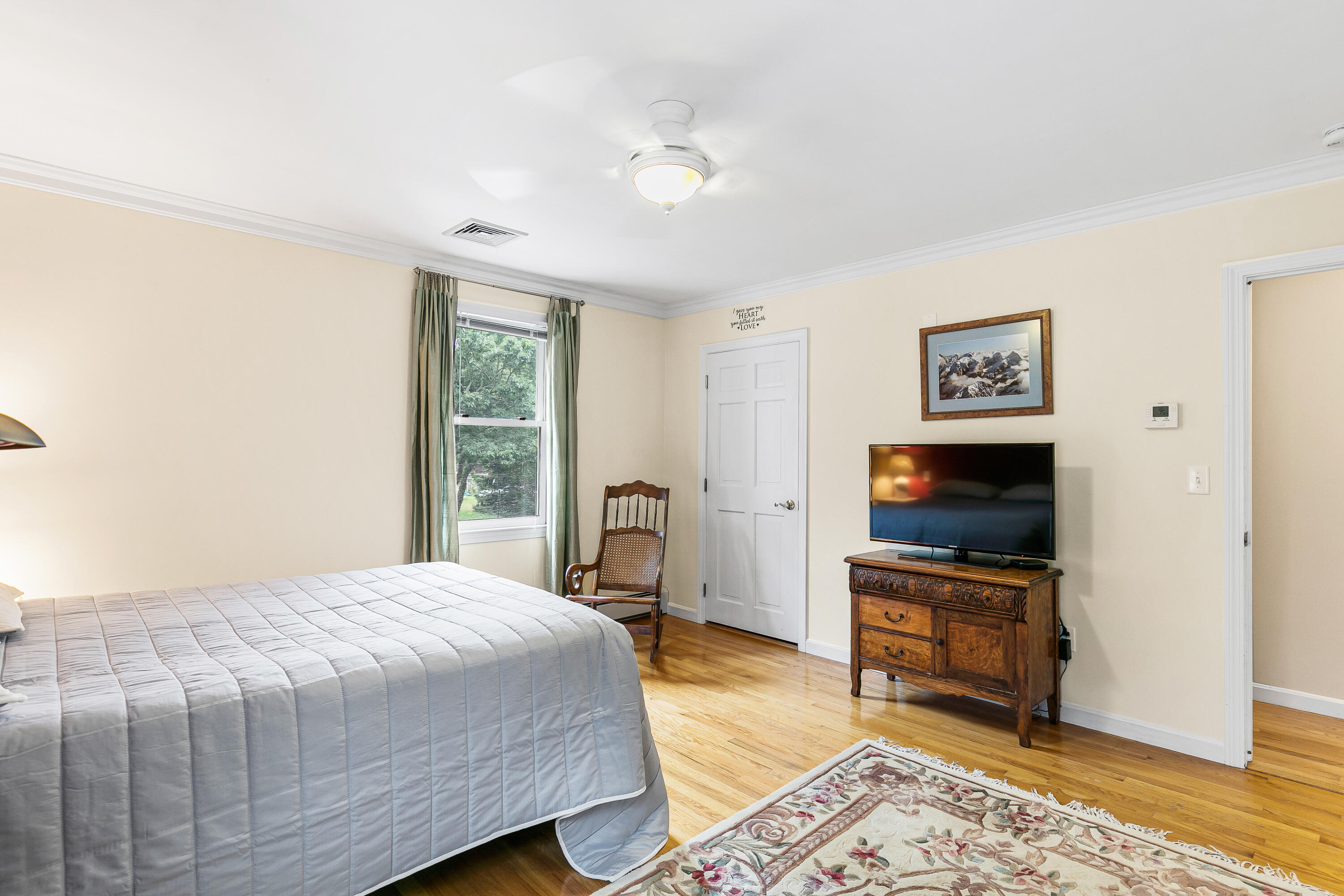 64 Hilltop Road Mashpee, MA 02649 - Photo 26 of 36 a bedroom with a bed and a flat screen tv