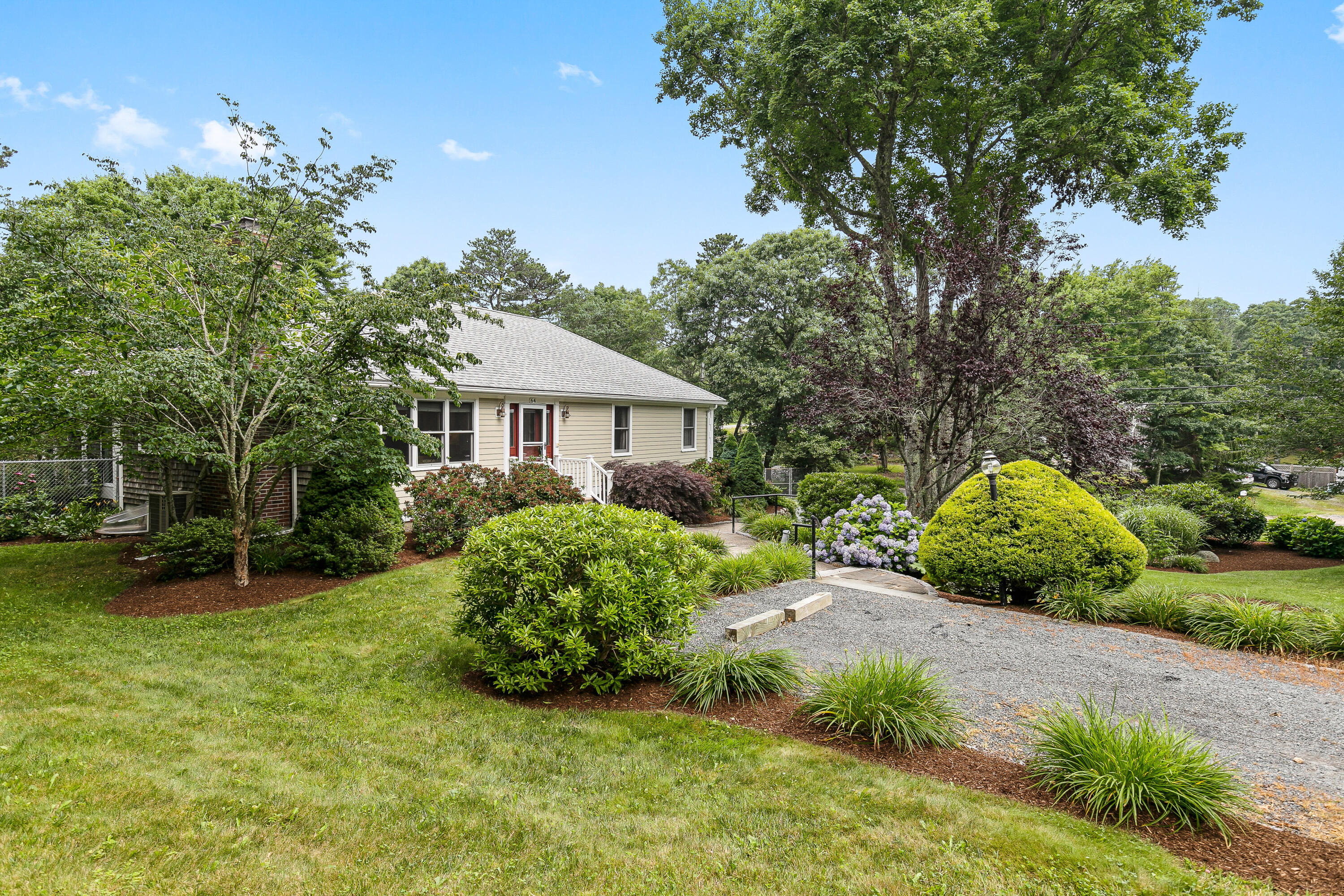 64 Hilltop Road Mashpee, MA 02649 - Photo 3 of 36 a front view of a house with garden