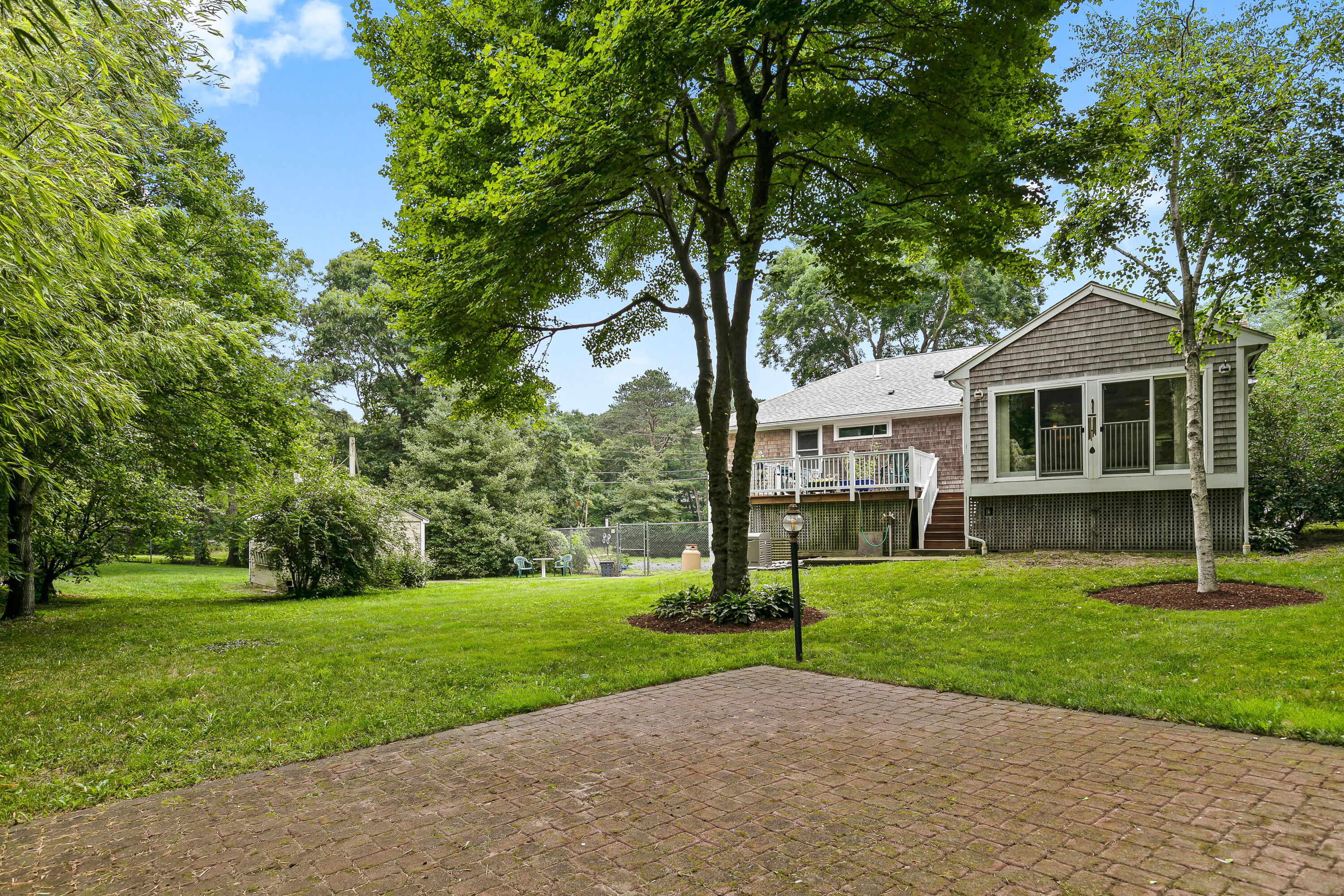 64 Hilltop Road Mashpee, MA 02649 - Photo 34 of 36 a front view of a house with a yard