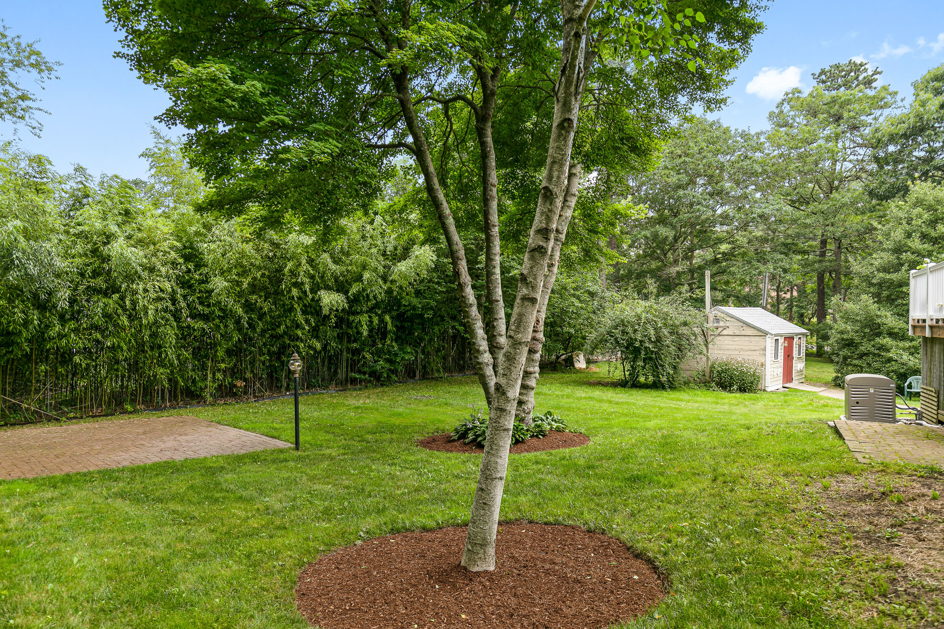 64 Hilltop Road Mashpee, MA 02649 - Photo 35 of 36 a view of a house with a backyard