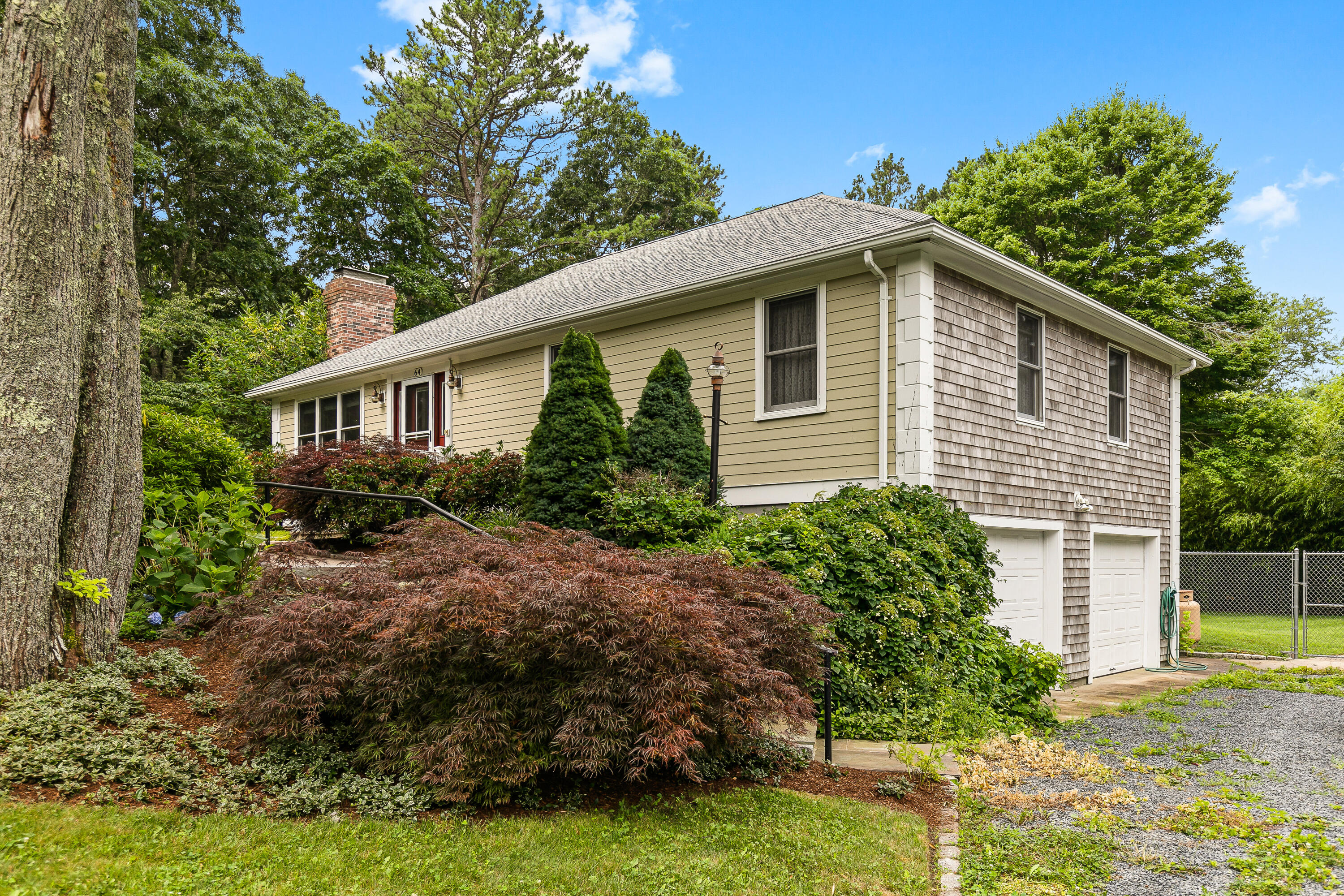 64 Hilltop Road Mashpee, MA 02649 - Photo 4 of 36 a front view of a house with garden