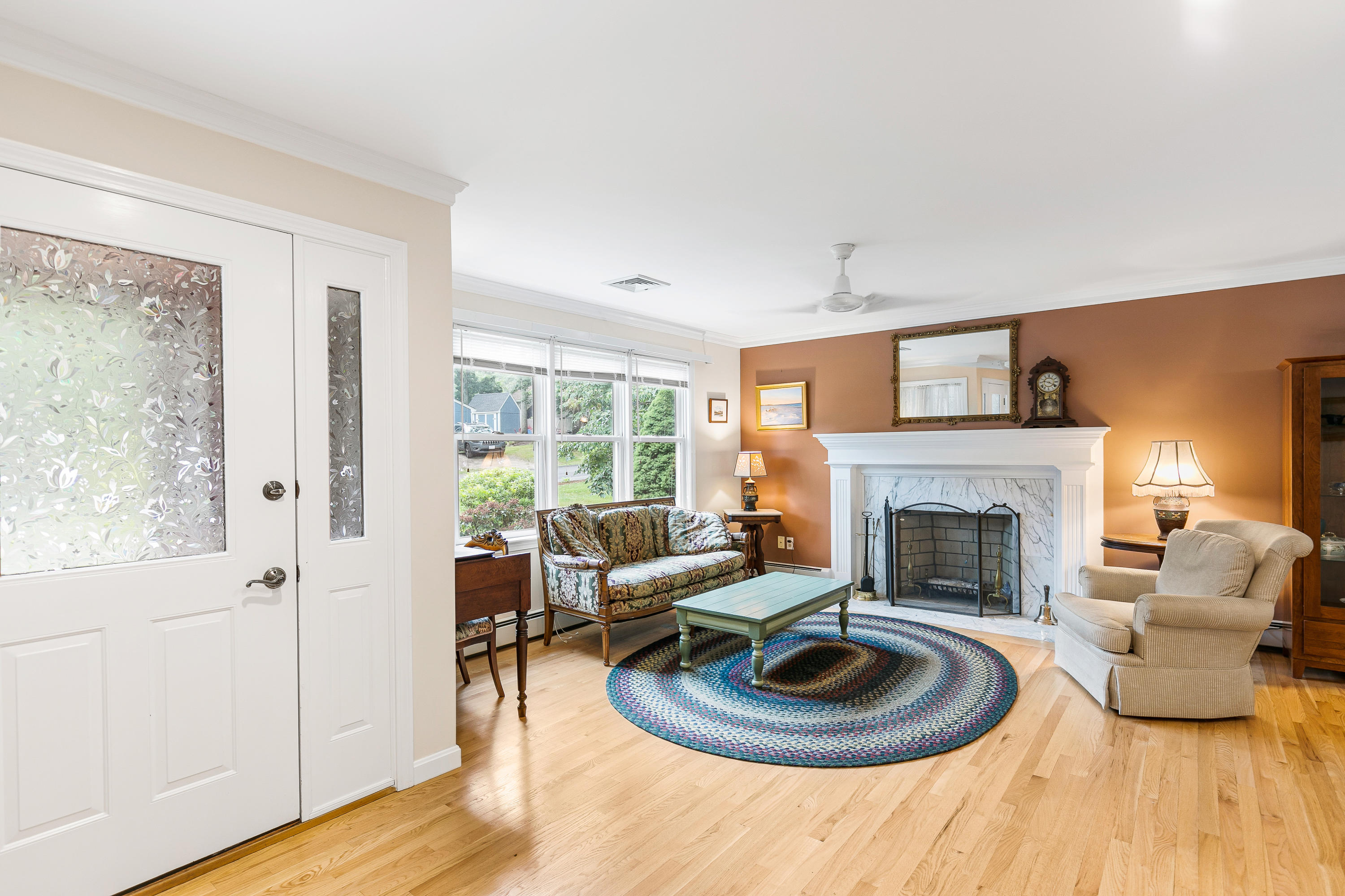 64 Hilltop Road Mashpee, MA 02649 - Photo 5 of 36 a living room with furniture and a fireplace