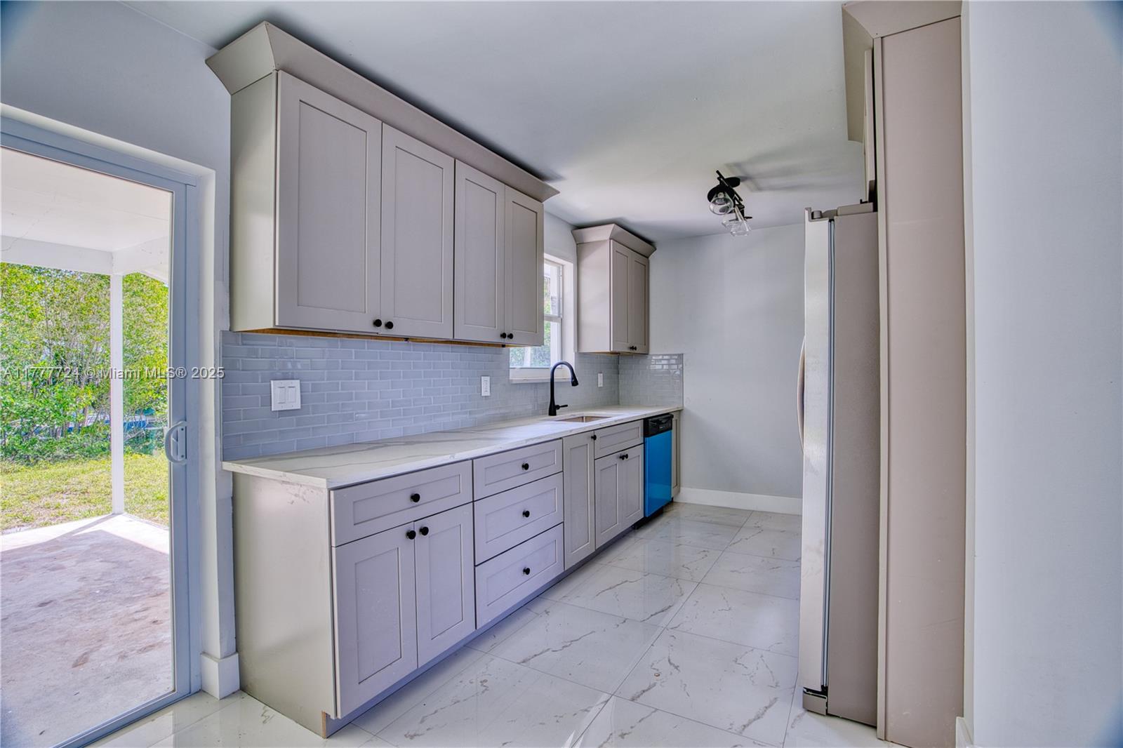 697 Pawnee Street Jupiter, FL 33458 - Photo 11 of 46 a kitchen with sink cabinets and a window