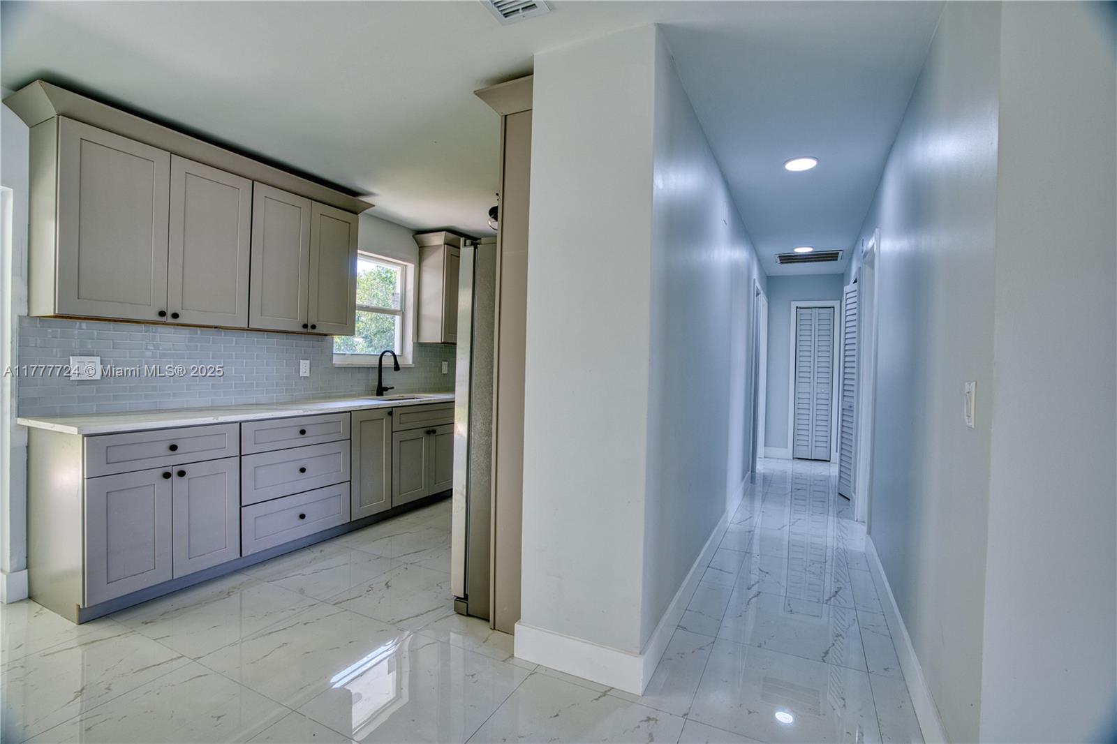 697 Pawnee Street Jupiter, FL 33458 - Photo 16 of 46 a view of cabinets a sink and dishwasher in a room