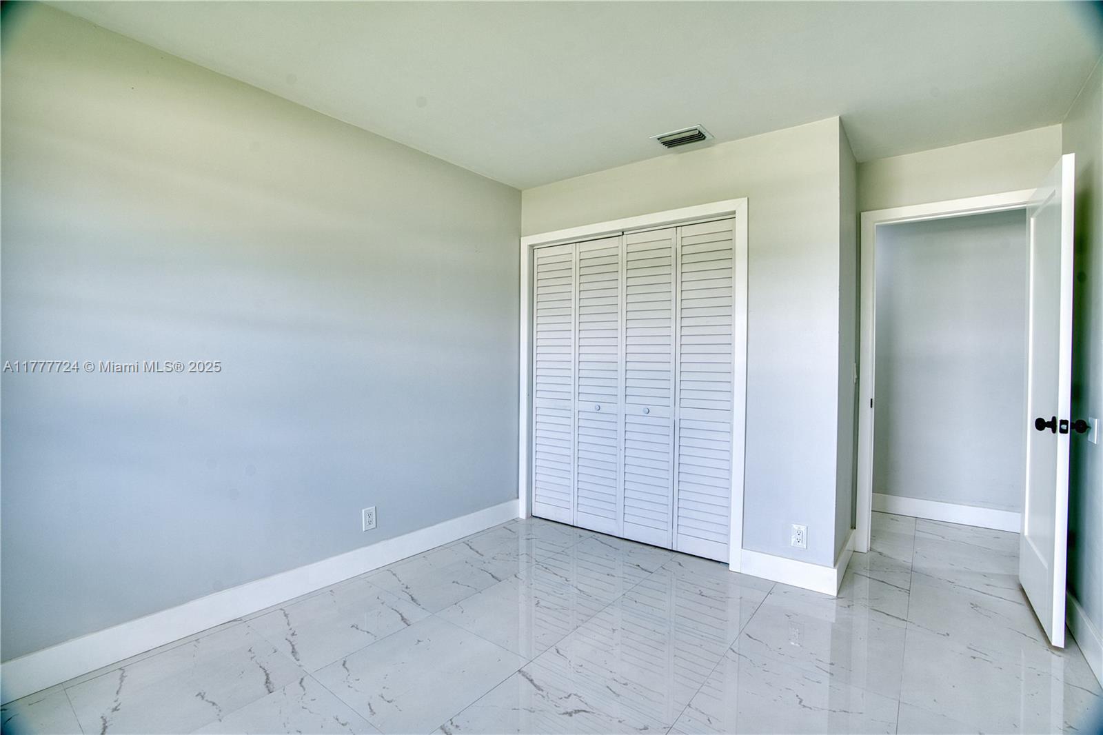 697 Pawnee Street Jupiter, FL 33458 - Photo 27 of 46 an empty room with windows