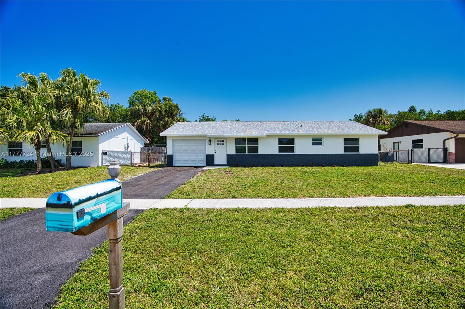 697 Pawnee Street Jupiter, FL 33458 - Photo 28 of 46 a house view with a garden space
