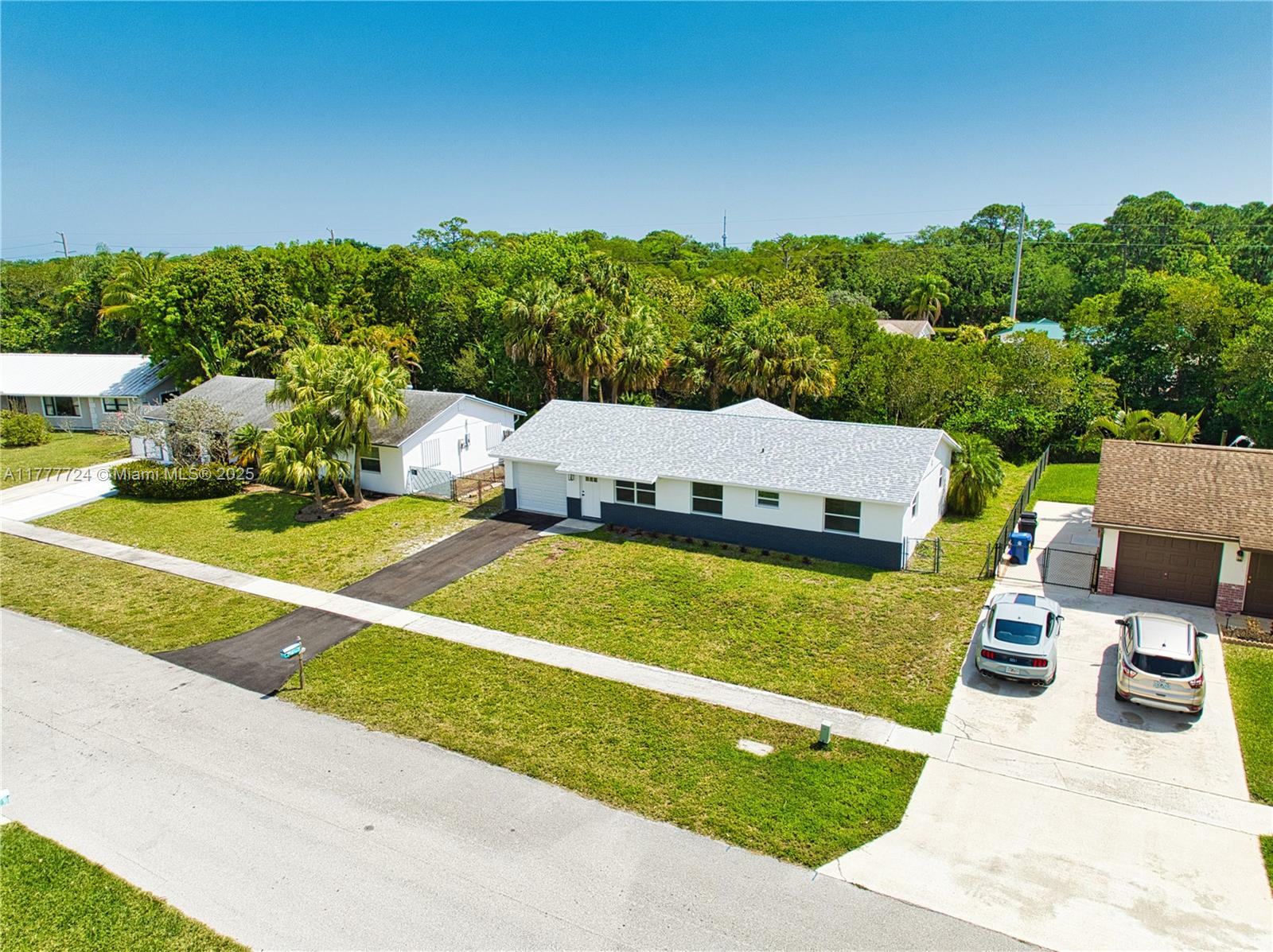 697 Pawnee Street Jupiter, FL 33458 - Photo 3 of 46 an aerial view of a house with swimming pool garden and patio
