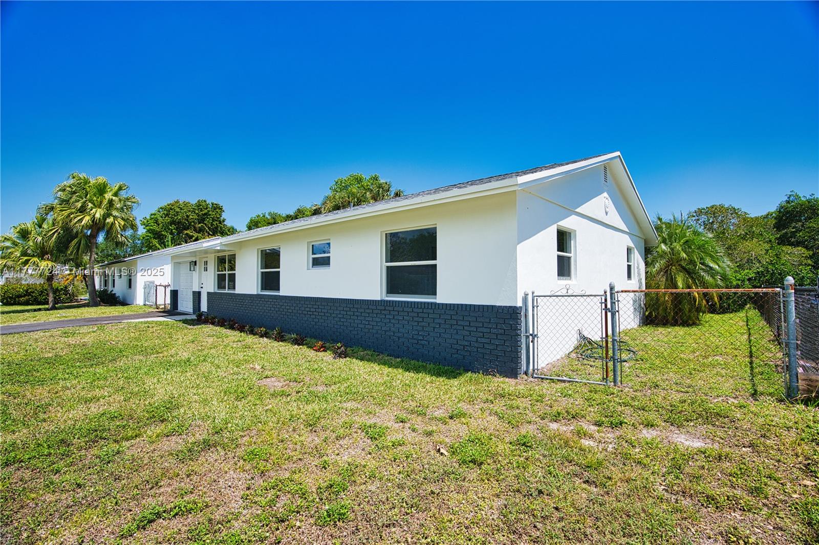 697 Pawnee Street Jupiter, FL 33458 - Photo 31 of 46 a view of house with backyard and trees