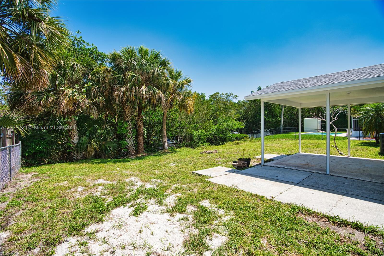 697 Pawnee Street Jupiter, FL 33458 - Photo 34 of 46 a view of a backyard with a small cabin