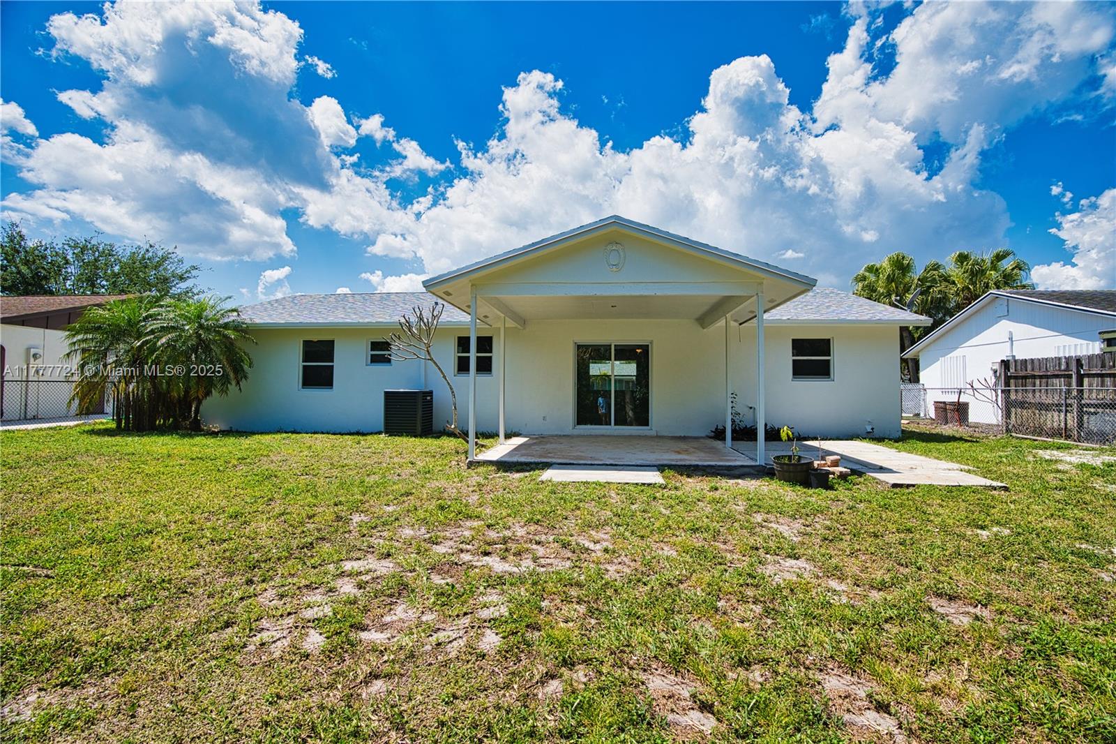697 Pawnee Street Jupiter, FL 33458 - Photo 36 of 46 a view of a house with a yard and potted plants