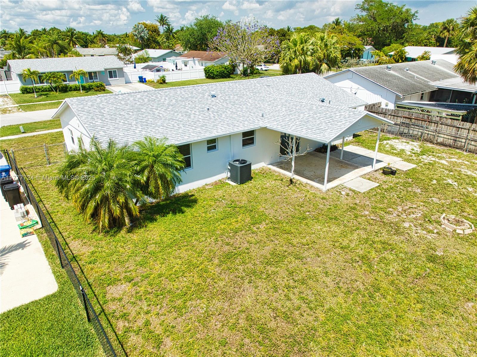 697 Pawnee Street Jupiter, FL 33458 - Photo 4 of 46 an aerial view of a house with a swimming pool
