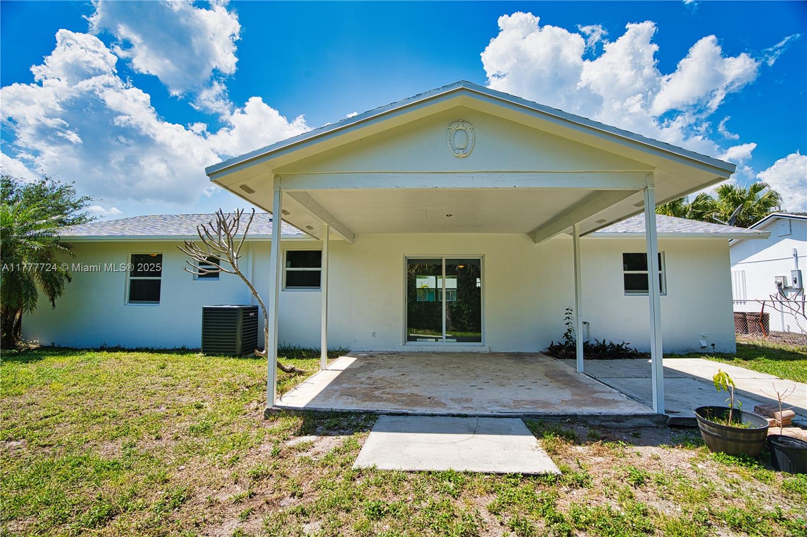 697 Pawnee Street Jupiter, FL 33458 - Photo 42 of 46 a front view of a house with garden