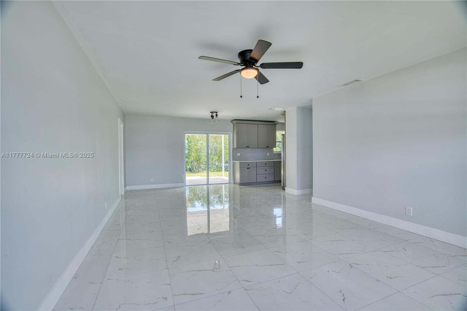 697 Pawnee Street Jupiter, FL 33458 - Photo 9 of 46 an empty room with windows and fan