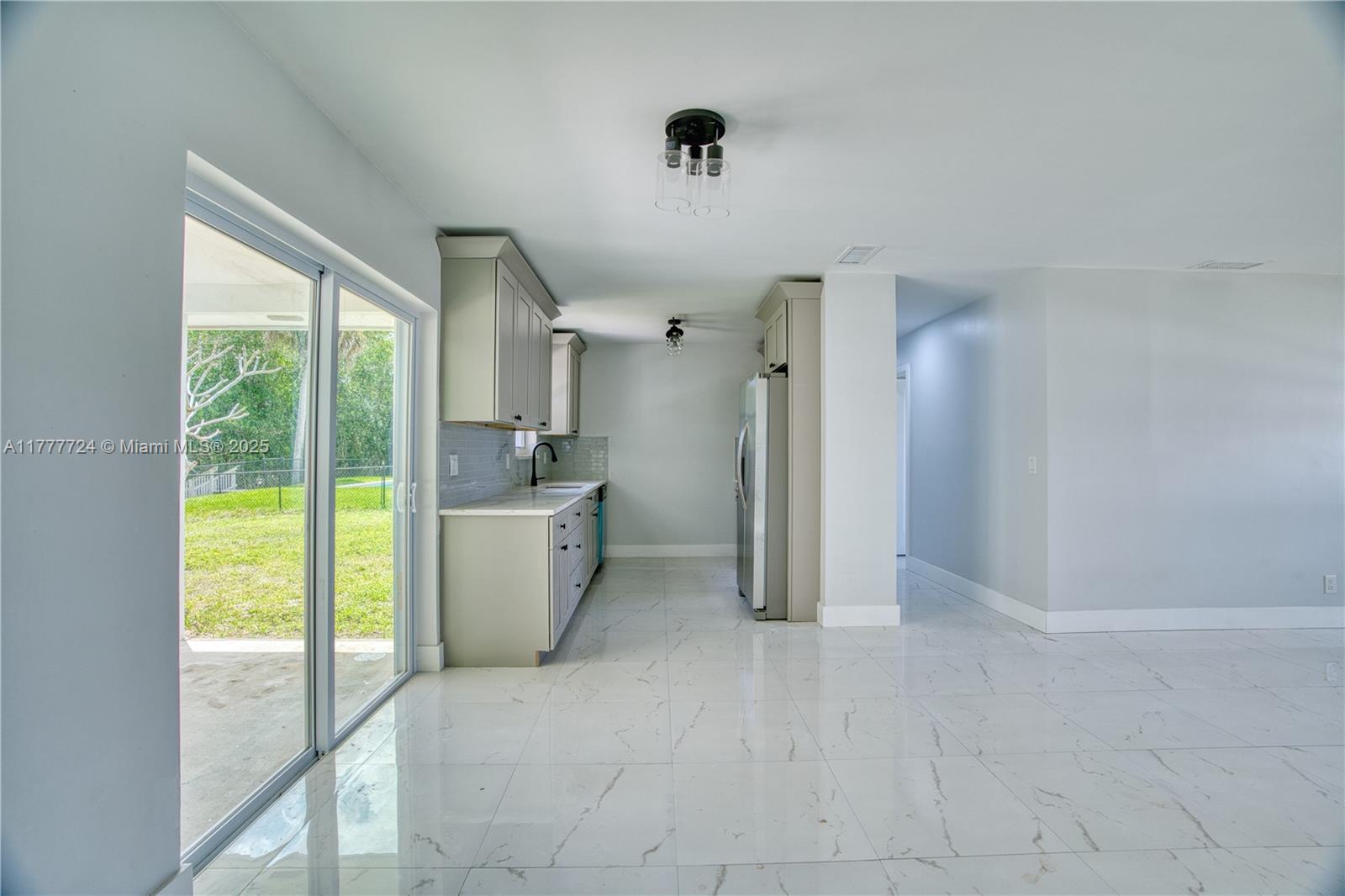 697 Pawnee Street Jupiter, FL 33458 - Photo 10 of 46 a view of a kitchen with a sink and a bath tub