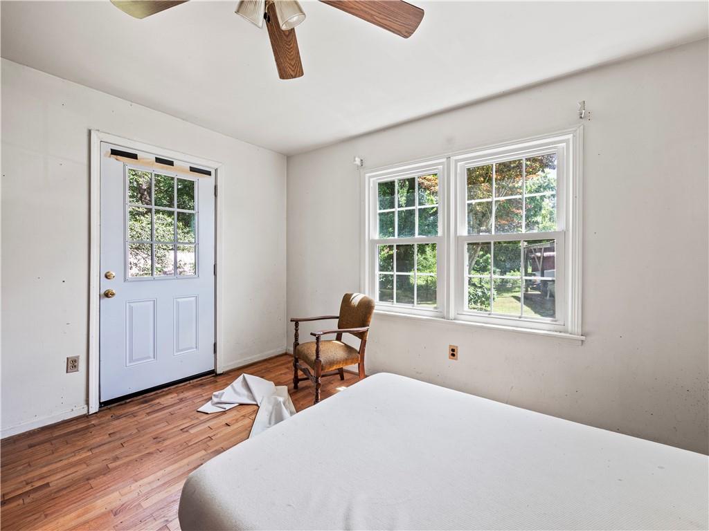 4065 Jot Em Down Road Cumming, GA 30028 - Photo 11 of 19 a bedroom with a bed and wooden floor