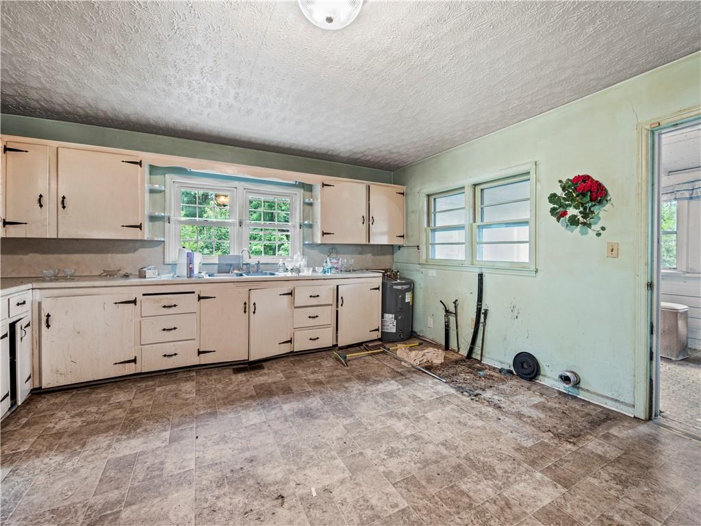 4065 Jot Em Down Road Cumming, GA 30028 - Photo 13 of 19 a kitchen with granite countertop a stove a sink dishwasher and a refrigerator
