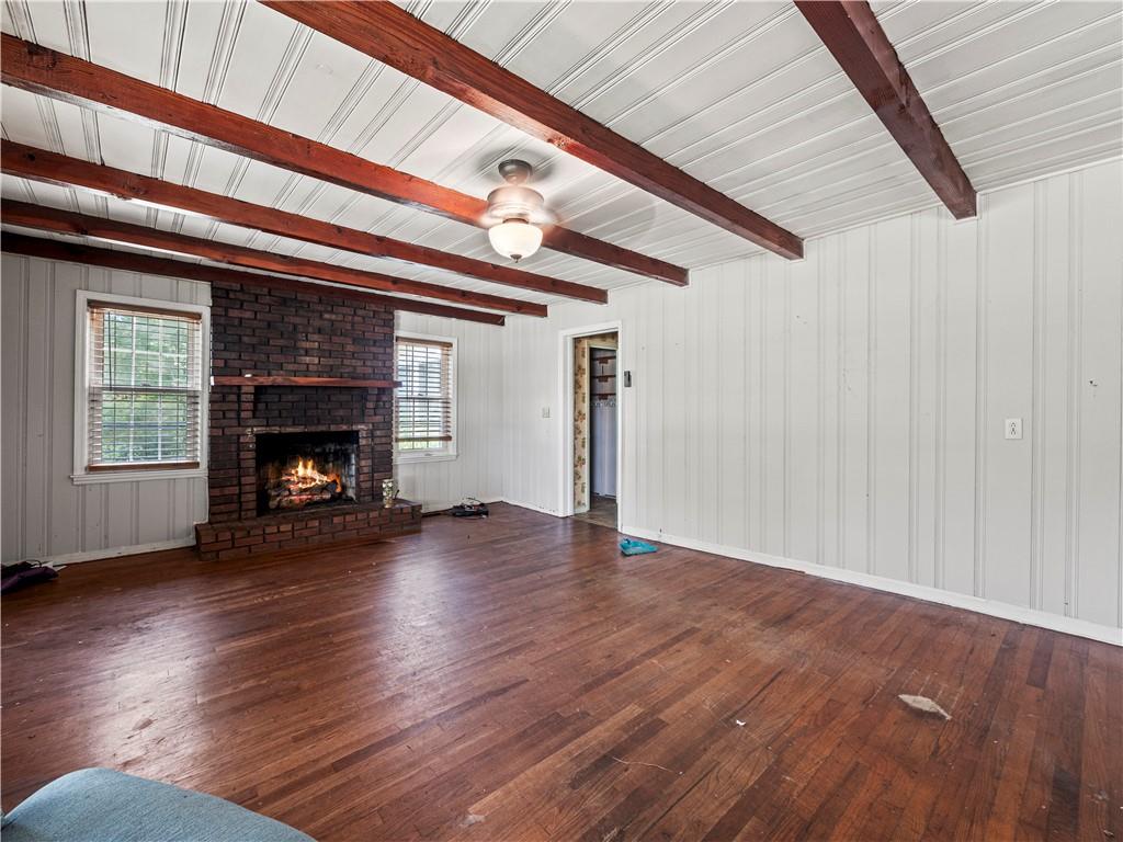 4065 Jot Em Down Road Cumming, GA 30028 - Photo 19 of 19 a view of an empty room with wooden floor fireplace and a window