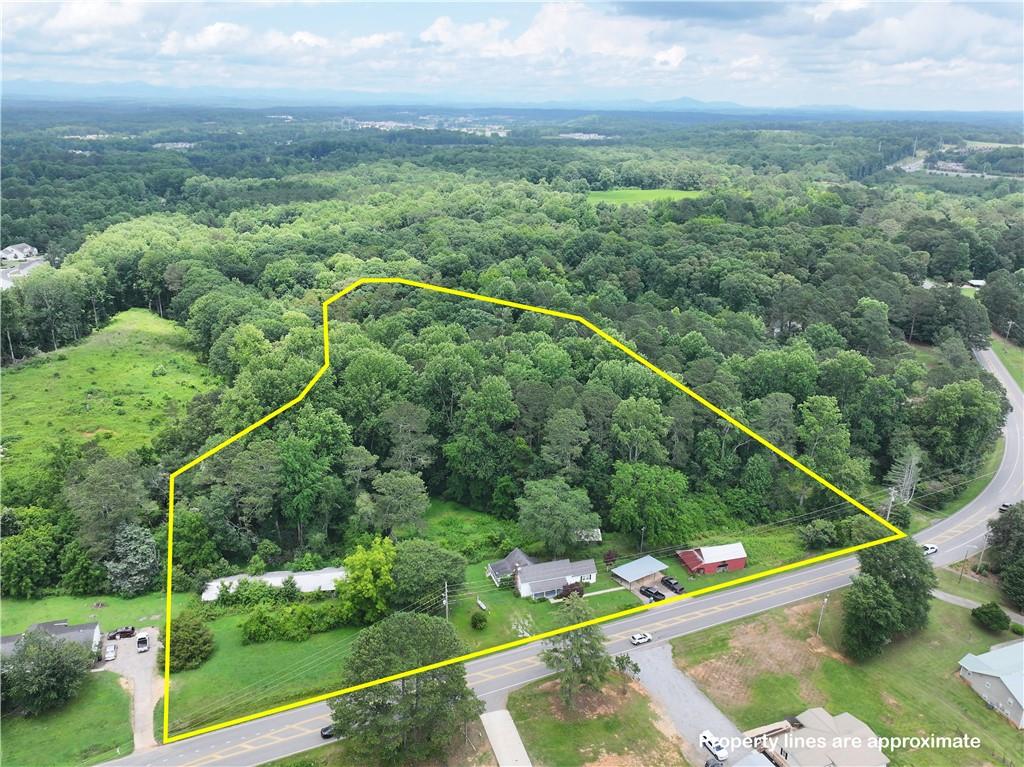 4065 Jot Em Down Road Cumming, GA 30028 - Photo 3 of 19 a view of a city with flower plants