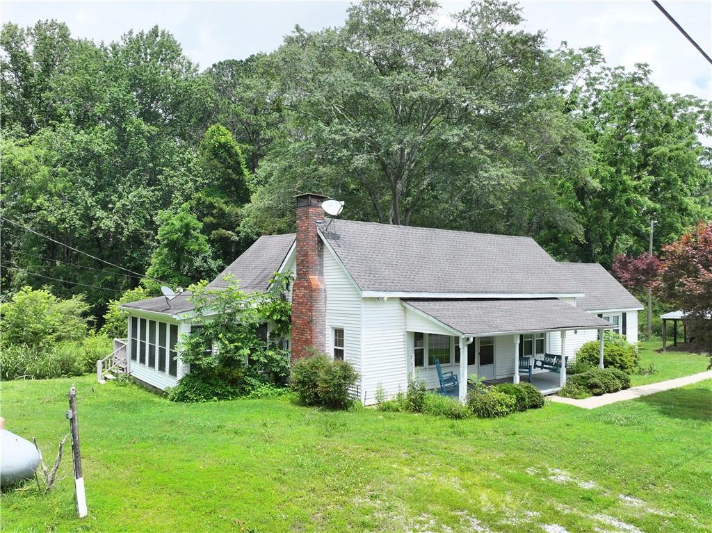 4065 Jot Em Down Road Cumming, GA 30028 - Photo 6 of 19 a aerial view of a house next to a big yard and large trees