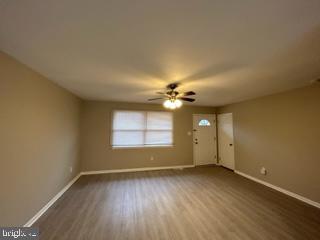 303 Three Bridge Road Monroeville, NJ 08343 - Photo 3 of 13 an empty room with wooden floor and windows