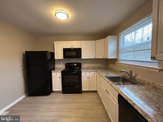 303 Three Bridge Road Monroeville, NJ 08343 - Photo 5 of 13 a kitchen with stainless steel appliances granite countertop a refrigerator and a sink