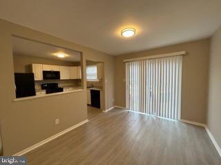 303 Three Bridge Road Monroeville, NJ 08343 - Photo 6 of 13 a view of a kitchen with a sink and dishwasher kitchen view with wooden floor