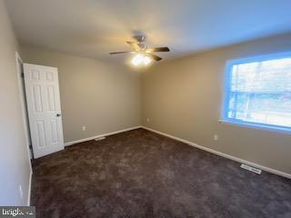 303 Three Bridge Road Monroeville, NJ 08343 - Photo 8 of 13 en empty room with windows and fan