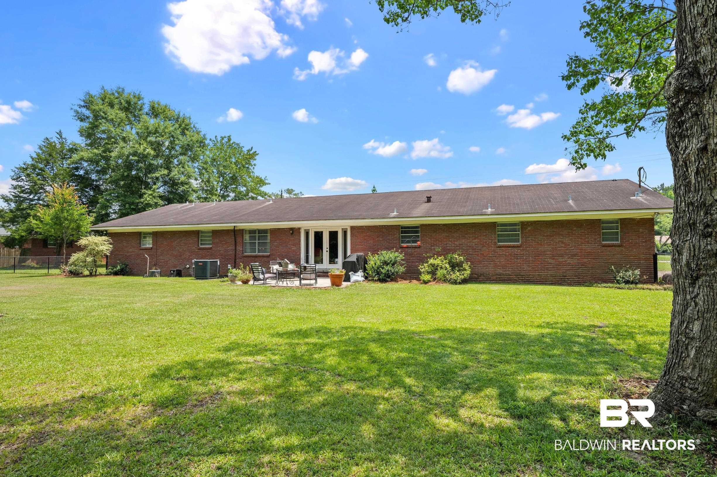 56 Old Bratt Road Atmore, AL 36502 - Photo 31 of 37 Back of property featuring french doors, brick siding, central AC unit, and a patio