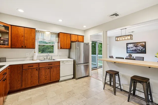 a kitchen with stainless steel appliances granite countertop a refrigerator and a sink