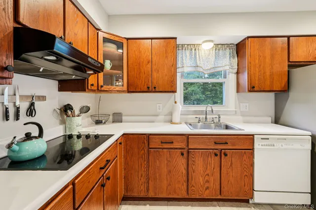 a kitchen with a sink cabinets and window