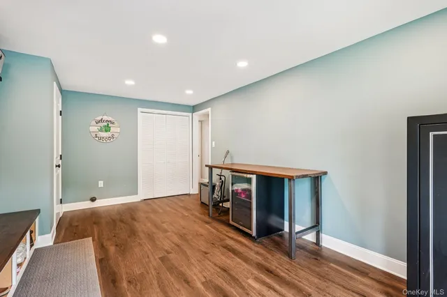 a view of a livingroom with furniture and a flat screen tv