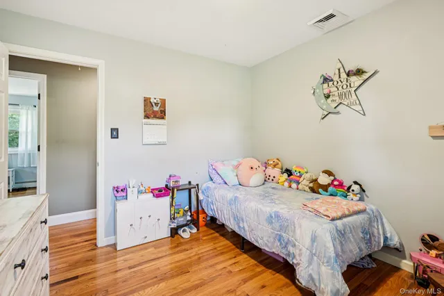 a bedroom with a bed and a television