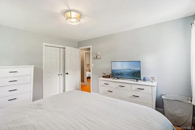 a bedroom with a bed and a dresser