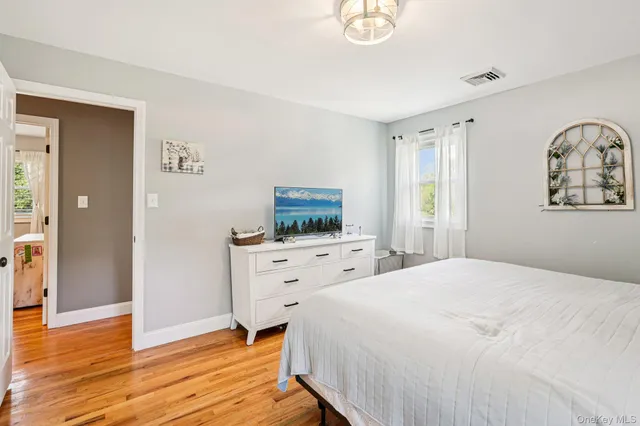 a bedroom with furniture and a window