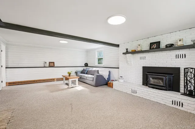 a living room with furniture and stairs