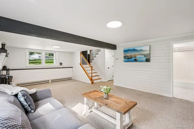 a view of an empty room with a fireplace and a window