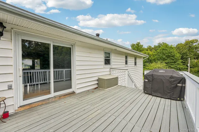 a view of balcony with wooden floor and fence