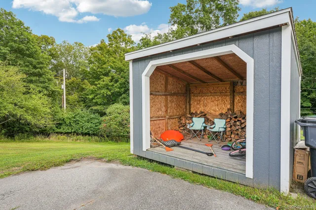 a backyard of a house with table and chairs