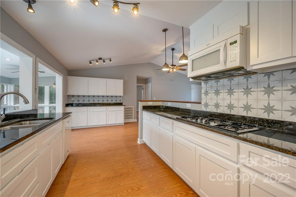 241 Hidden Hill Road Tryon, NC 28782 - Photo 11 of 39 a kitchen with stainless steel appliances granite countertop a stove and a sink
