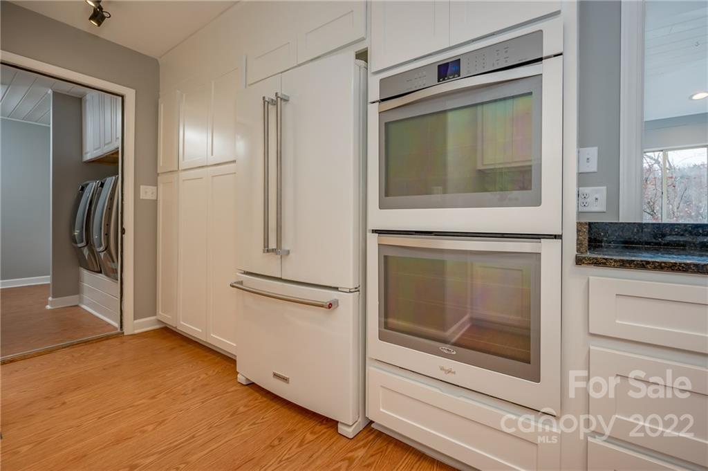 241 Hidden Hill Road Tryon, NC 28782 - Photo 12 of 39 a kitchen with a refrigerator and a stove