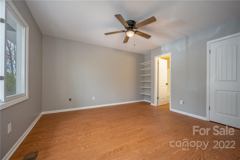 241 Hidden Hill Road Tryon, NC 28782 - Photo 18 of 39 an empty room with windows and fan