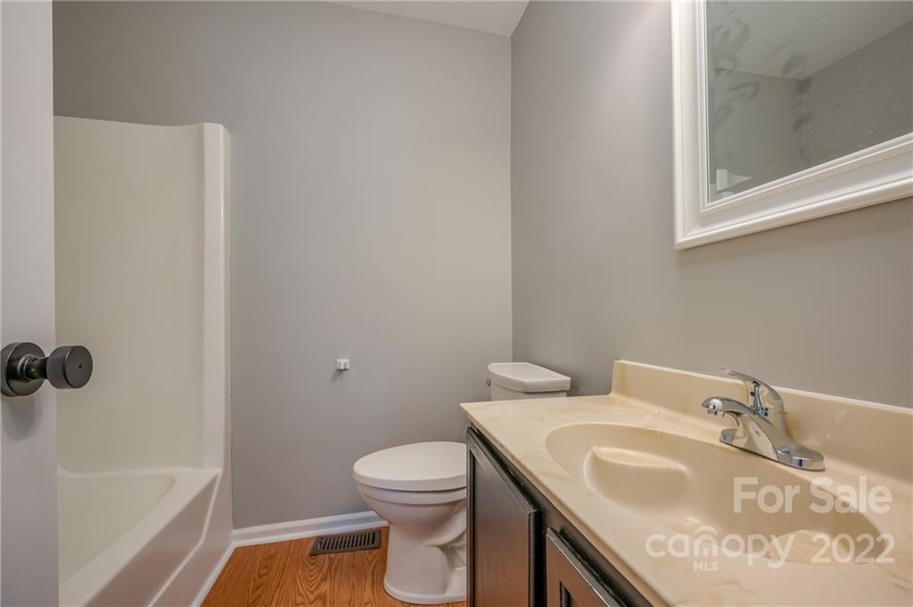 241 Hidden Hill Road Tryon, NC 28782 - Photo 20 of 39 a bathroom with a granite countertop sink toilet and shower